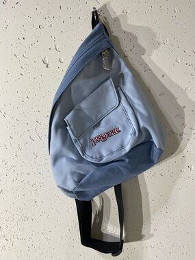 Jansport  red lettering Light Blue Sling Bag.